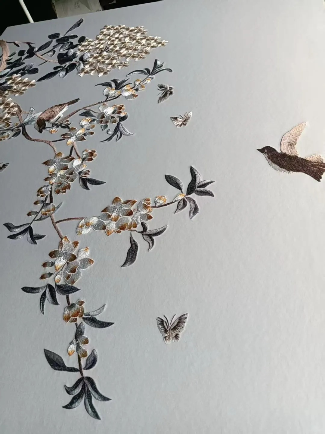 Bird and branch embroidered wallcovering panel