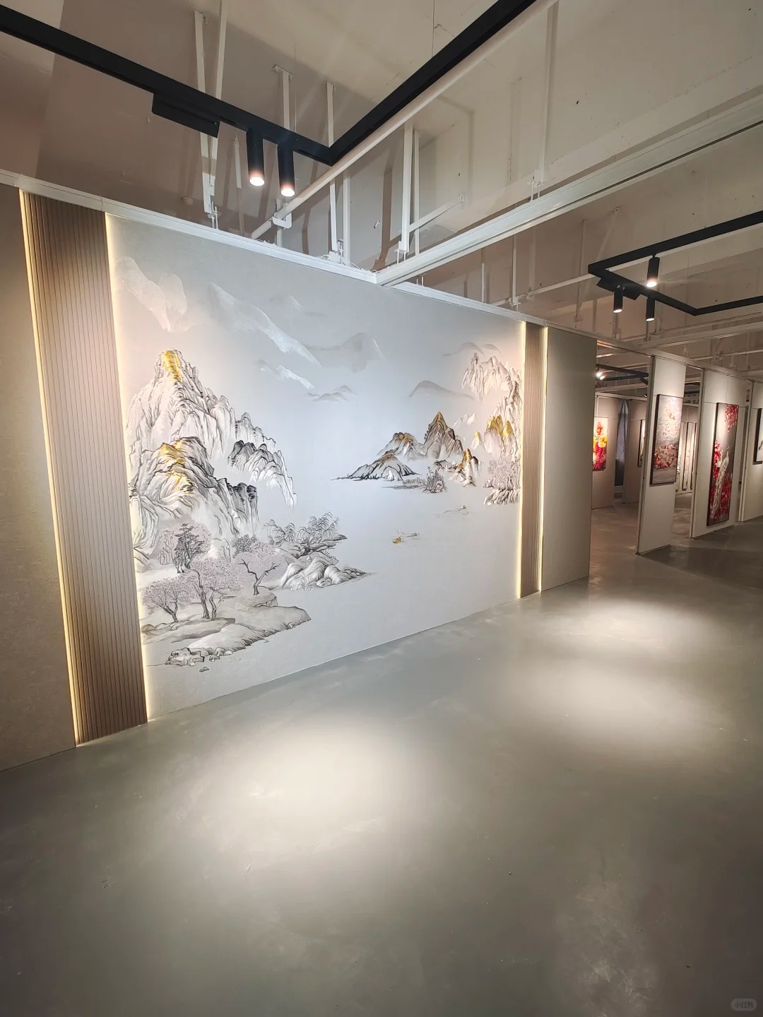 Showroom display with embroidered landscape wallcovering