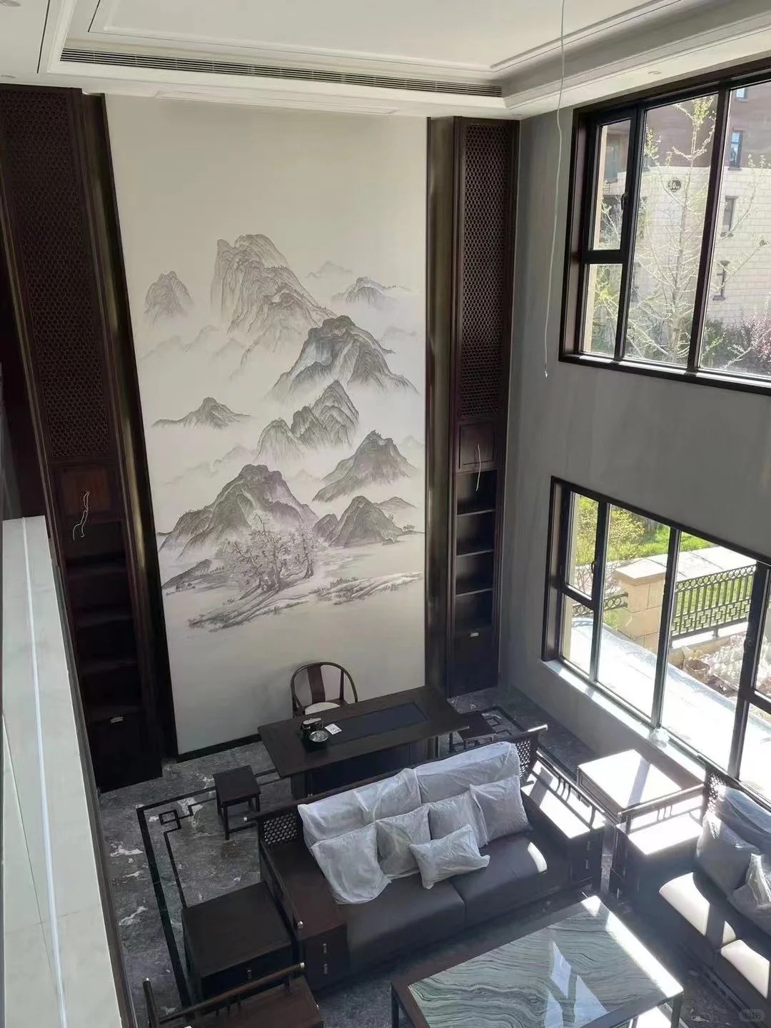 Tall villa living room with landscape feature wallcovering